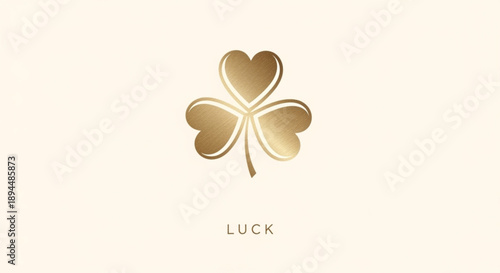 Golden four leaf clover with heart shaped leaves and the word 'luck' on a beige background symbolizing good fortune and positivity