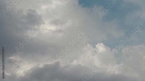 Time-lapse of fluffy white clouds drifting across a deep blue sky, illustrating the beauty of nature and the passage of time.