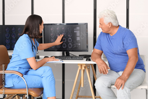 Female doctor showing x-ray...