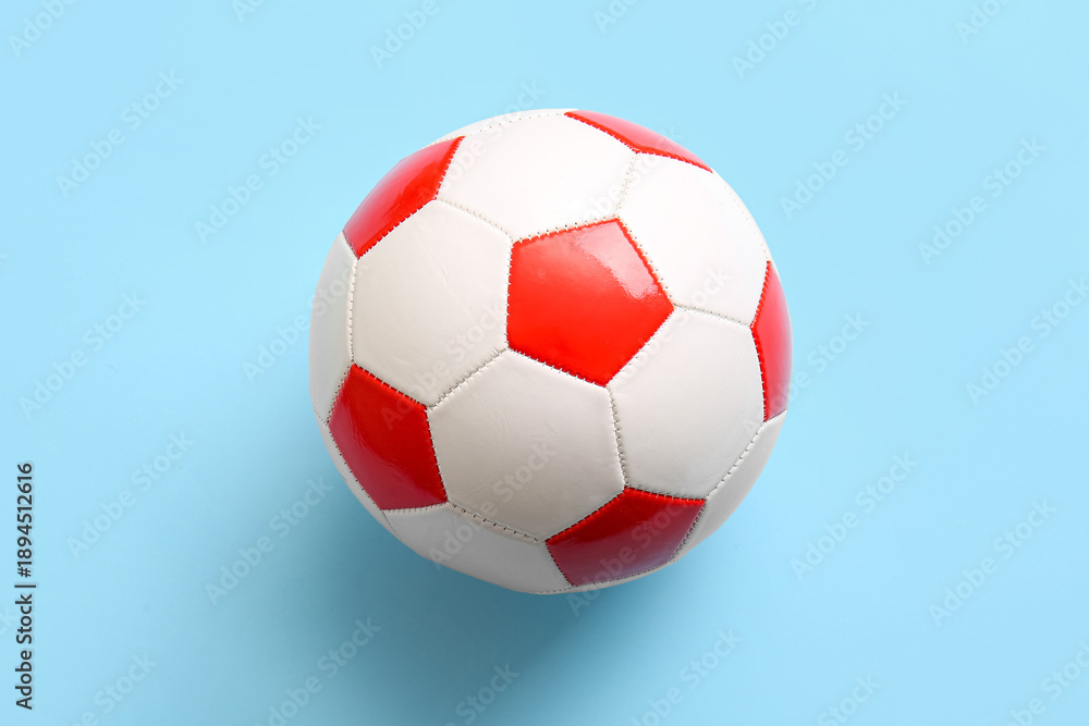 Fototapeta premium Soccer ball on light blue background