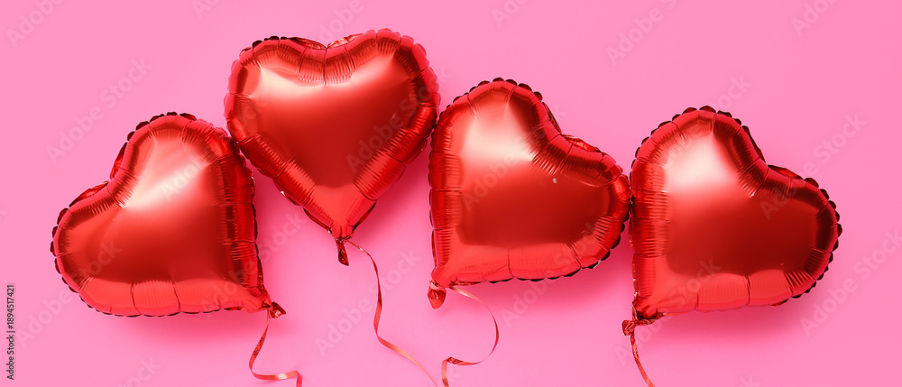 Fototapeta premium Red heart shaped air balloons on pink background. Valentine's day celebration