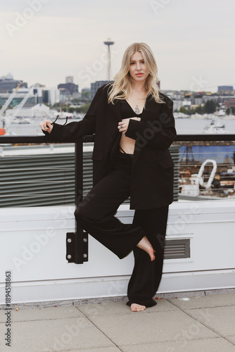 young woman standing on a bridge