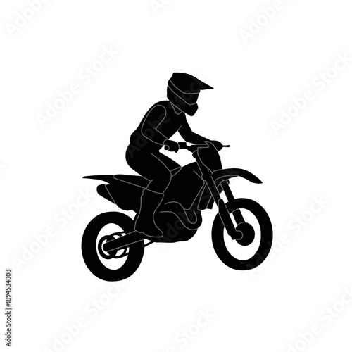 Silhouette of a motocross rider in action on a dirt bike.