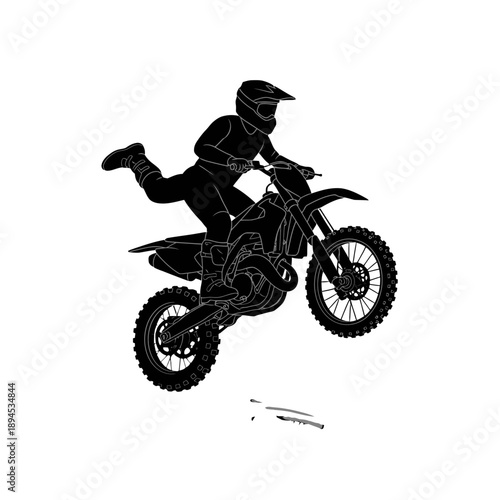 Silhouette of a motocross rider in mid-air on a dirt bike.