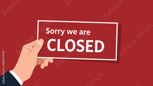 Person in a dark suit holding a red rectangular sign that says Sorry we are closed against a solid red background.