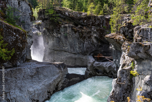 Waterfall spray rising from narrow slot canyon at Nairn Falls.
