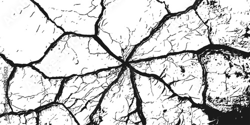 An abstract black and white texture of cracked dry earth and broken concrete reveals a rough stone pattern on an old weathered desert land surface