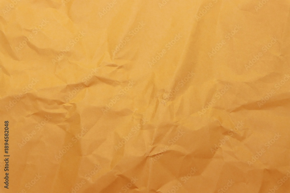 Fototapeta premium Wrinkled orange craft paper texture background