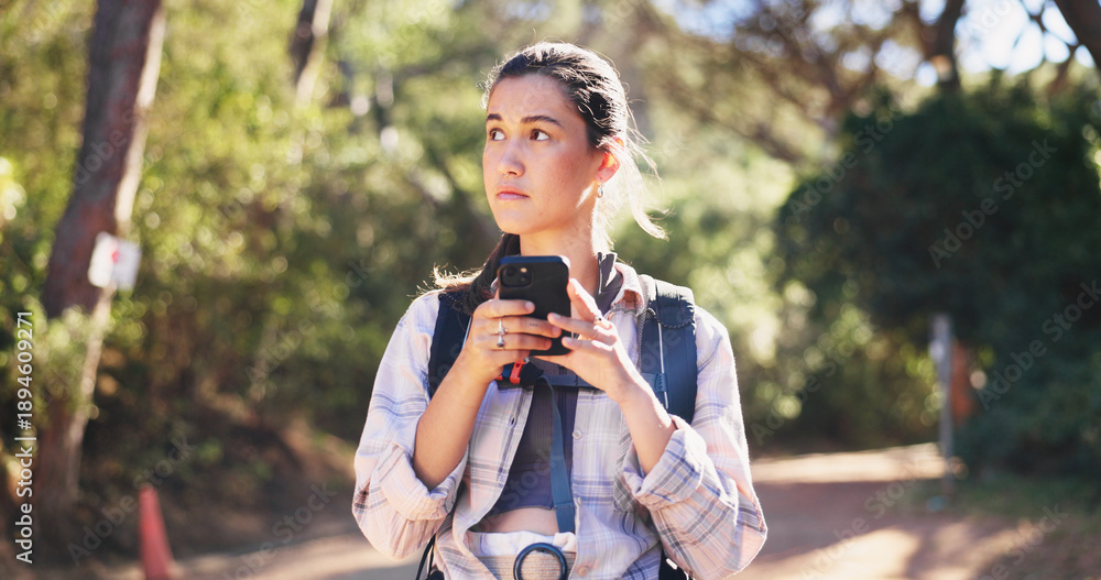 Obraz premium Phone, navigation and woman on path for hiking, network and guide in online direction. Travel, route and female person in forest with tech, map tracking and location search on outdoor adventure.