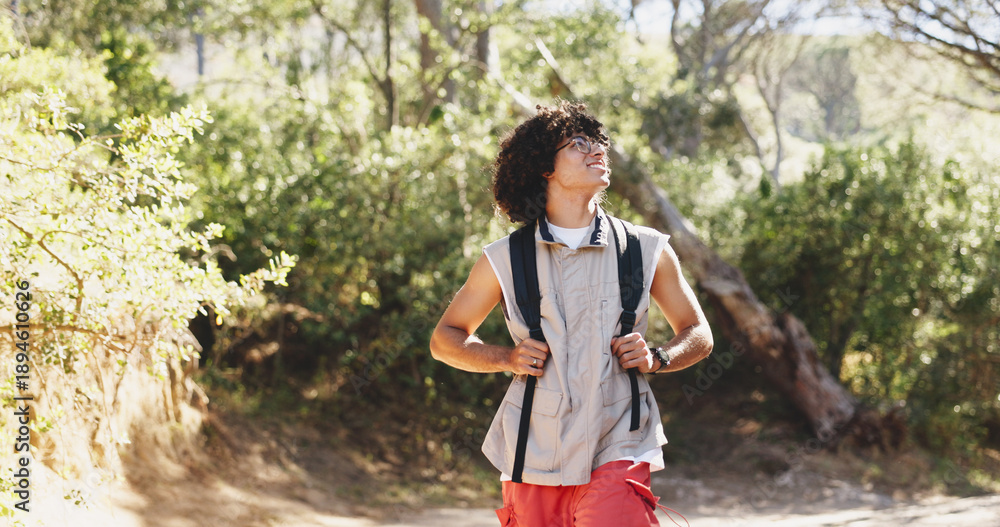 Obraz premium Man, happy and thinking with hiking in forest for adventure, outdoor and getaway on holiday. Person, smile and nature tourism with perspective for reflection, break or view with trekking in woods