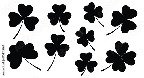 A collection of eight black four leaf clovers displayed in varying orientations on transparent background silhouette high quality professional detailed modern elegant