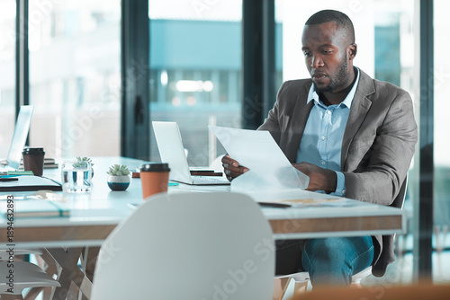 Fotografie Paperwork, reading or black man in office for audit, planning tax return or check reimbursement form