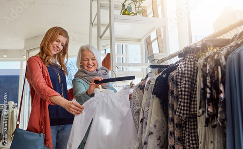 Картината върху платно Clothes, shopping and woman with senior parent in clothing store together for retail sale