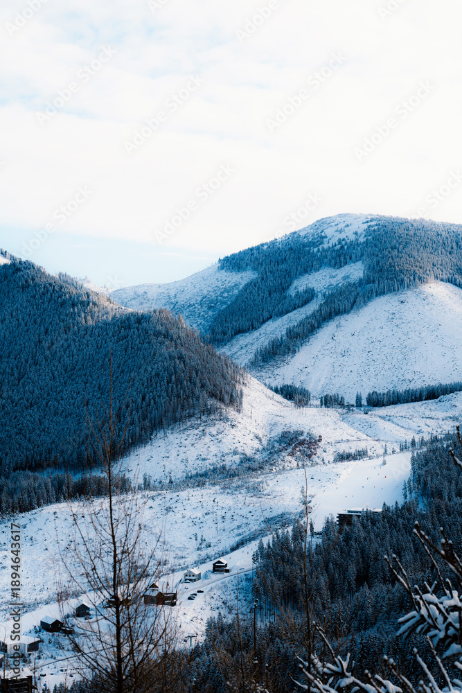 Obraz premium Jasná ski resort in the Low Tatras Mountains, located in the Liptov region of Slovakia. Snow-covered peaks, alpine slopes, and winter landscape create a popular destination for skiing