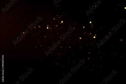Golden abstract bokeh on black background.