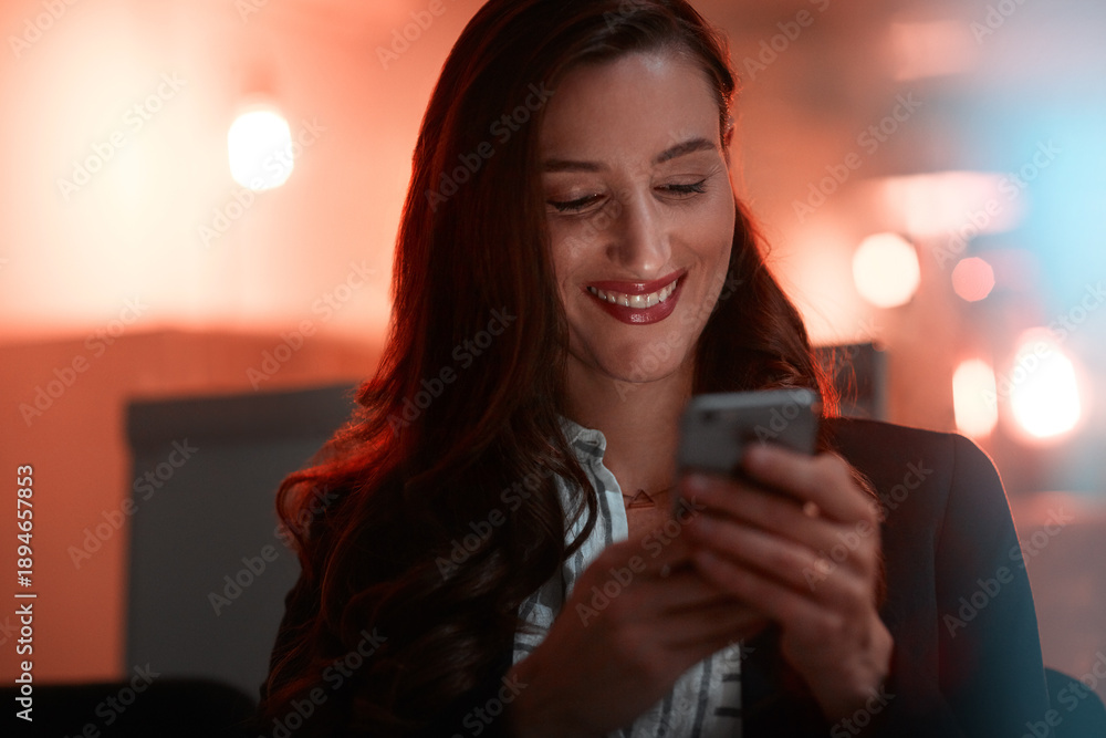 Fototapeta premium Happy, woman and typing with phone in office for article approval, publication feedback and night. Overtime, journalist and smartphone at media agency for client quote, reading news report and email