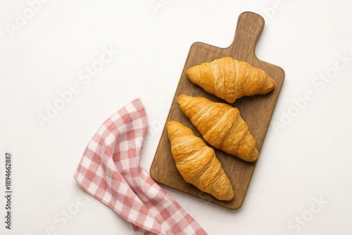 Fresh Baked Butter Croissants on Wooden Cutting Board with Red Gingham Napkin