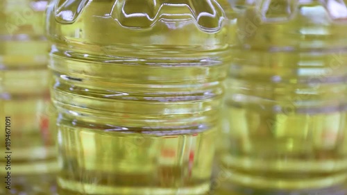 Cooking oil bottles with yellow vegetable oil, close-up. Food industry concept, edible oil production, cooking ingredients, suitable for business and commercial content