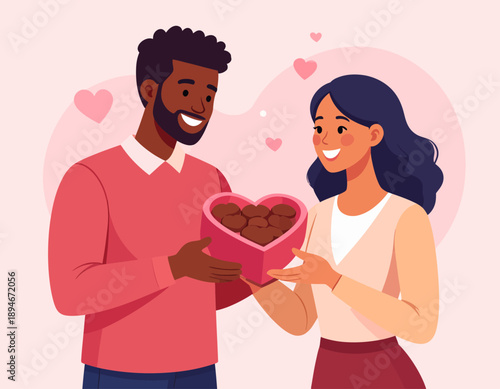 A smiling man gives a heart-shaped box of chocolates to a happy woman, celebrating love and affection.