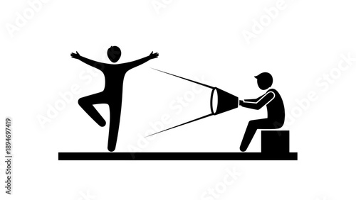 Filmmaker captures dancer performing ballet pose on stage.