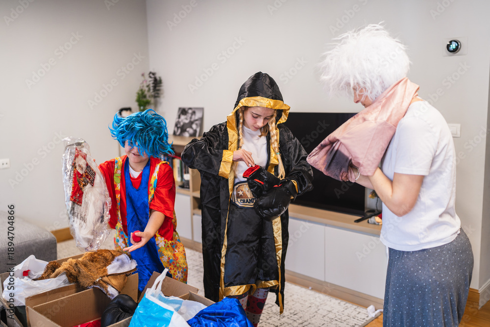 Fototapeta premium Family members exploring a box of dress up clothes, trying on wigs and costumes for carnival entertainment at home