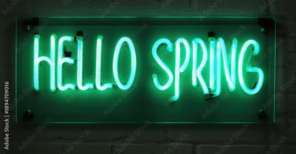 Obraz premium Bright neon sign displays Hello Spring. Turquoise glow contrasts dark brick wall. Simple message evokes seasonal change, optimism.