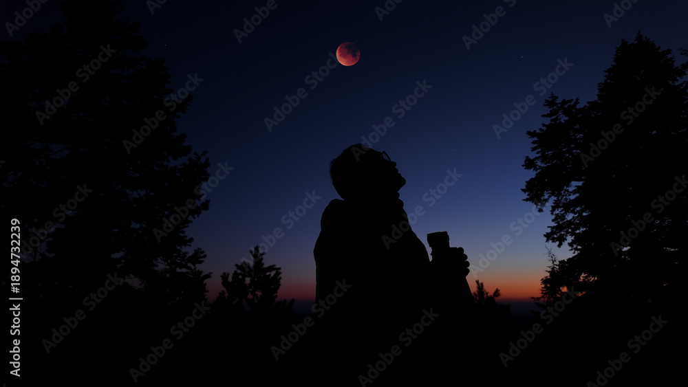 Fototapeta premium Amateur astronomer using binoculars for observing stars, planets, Moon and other celestial objects.