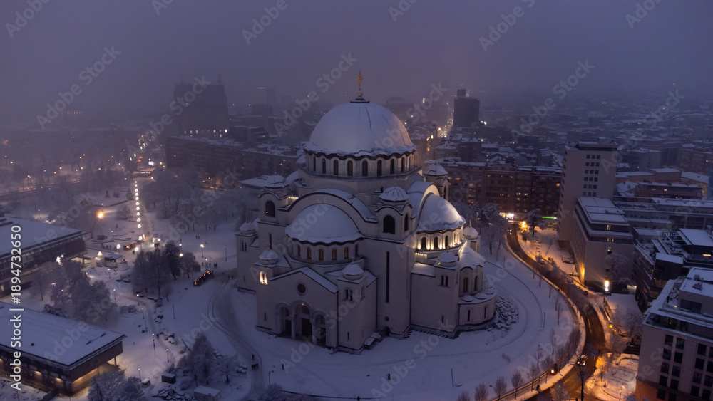 Fototapeta premium Drone view of Saint Sava, orthodox church in Belgrade, Serbia in winter snowing time.