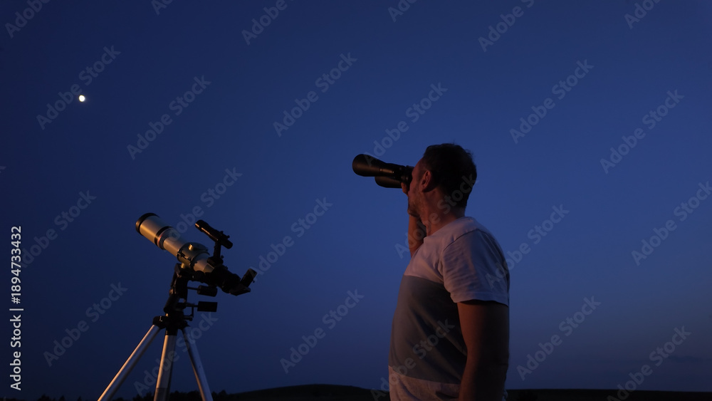 Fototapeta premium Amateur astronomer using telescope and binoculars for watching stars, Moon, planets and other celestial objects from a field in nature.