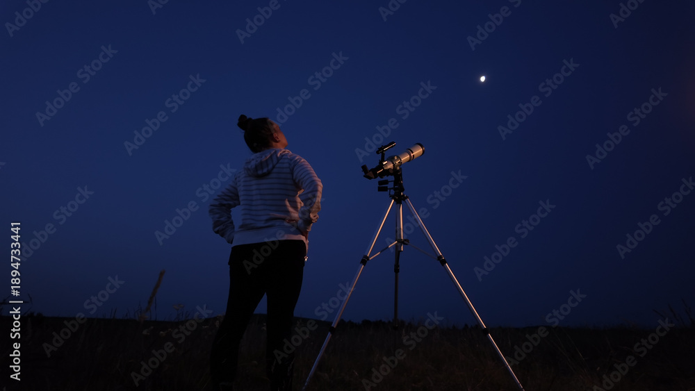 Fototapeta premium Amateur astronomer using telescope for watching stars, Moon, planets and other celestial objects from a field in nature.
