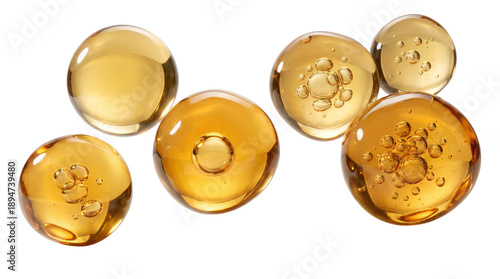 Set of golden liquid spheres with internal bubbles in glossy glass style
