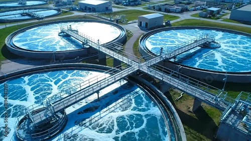 Industrial water treatment plant aerial view with multiple circular tanks