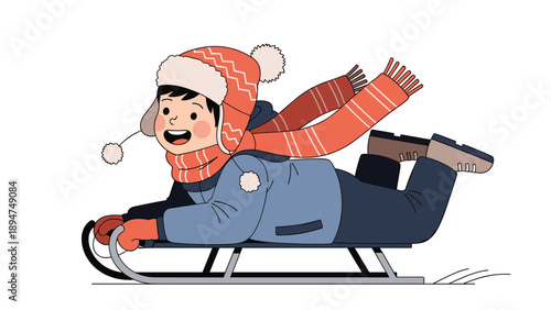 Happy young boy wearing warm winter clothes and a red scarf enjoying a fast sled ride on a snowy hill outdoors.