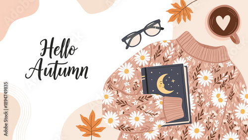 Beautiful autumn flat lay featuring a floral sweater, a book with a moon, eyeglasses, coffee, and fallen leaves.