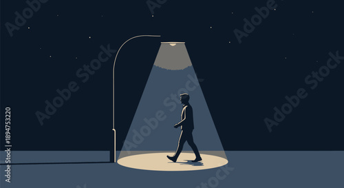 Solitary figure walking purposefully across a brightly illuminated circle of light cast by a streetlamp late at night beneath a starry sky