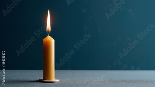 Wallpaper Mural beeswax taper candle with a steady warm flame against a deep midnight blue background Torontodigital.ca