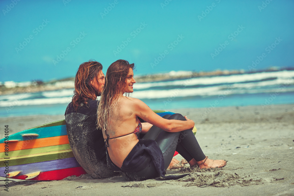 Fototapeta premium Thinking, couple and relax on beach with surfboard for travel, adventure or bonding on holiday. Space, thoughts and surfer people with vision, fitness reflection and daydreaming on vacation in nature