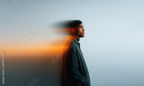 Artistic Side Profile Portrait of Young Man Against White Wall With Abstract Light Reflections and Orange Glow in Dreamy Atmosphere