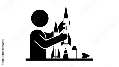 Person assembling model rockets on a table.