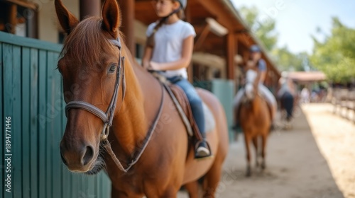 Horses in Stable with Riders Preparing for Ride in Outdoor Equestrian Setting