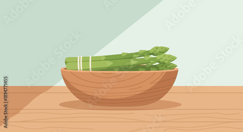 Fresh asparagus spears tied with twine in a wooden bowl on a table