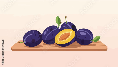 Fresh purple plums, one sliced, arranged on a wooden cutting board