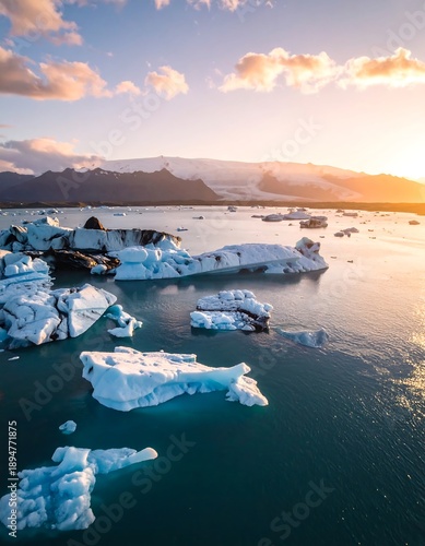Aerial view of icebergs floating on serene water at sunset