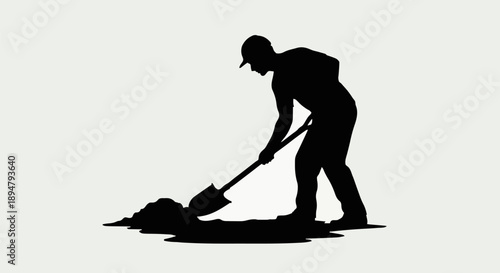 Silhouette of a construction worker digging with a shovel.