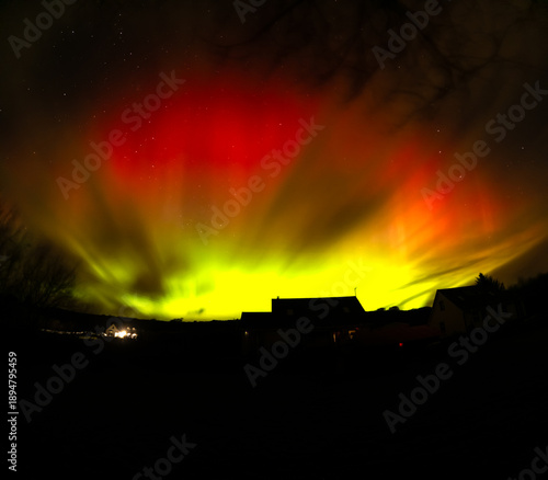 The Aurora Borealis, the northern lights, showing up above bungalow in County Donegal, Ireland