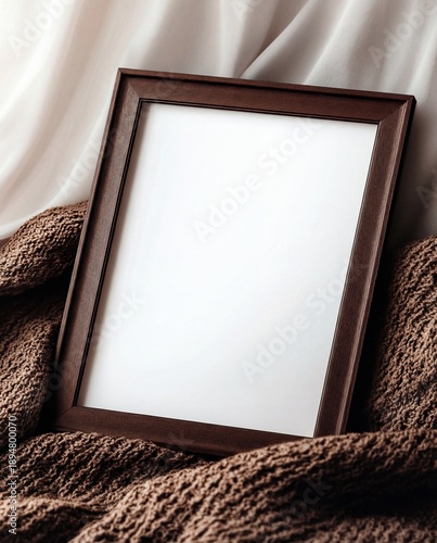 empty wooden picture frame mockup on a cozy brown knitted blanket