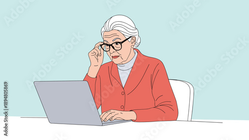 Focused senior woman with white hair wearing glasses while working on a laptop at a white desk for lifelong learning and technology.