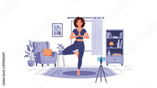 Healthy woman practicing tree pose yoga in her stylish living room while using a smartphone on a tripod for a virtual class.