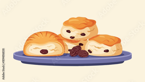A plate of three cartoon-style raisin buns with loose raisins