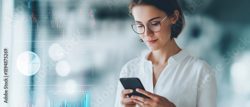 Wallpaper Mural A businesswoman with glasses looks at her smartphone with financial data displayed. Torontodigital.ca